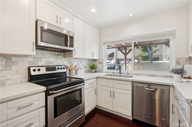 1846 Rosebrook Ln, Rosemead, CA 91770 - kitchen with appliances with stainless steel finishes, white cabinets, tasteful backsplash, dark wood finished floors, and recessed lighting