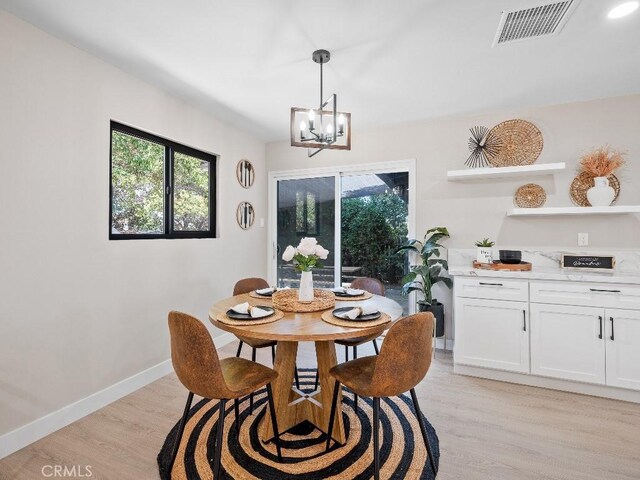 971 N Clifford Ave, Rialto, CA 92376 - dining space with light wood-style flooring, a chandelier, and healthy amount of natural light