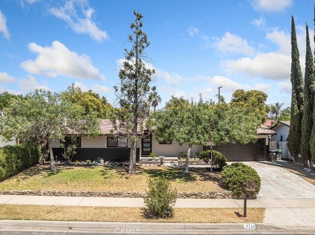 971 N Clifford Ave, Rialto, CA 92376 - obstructed view of property featuring concrete driveway, a garage, and a front yard