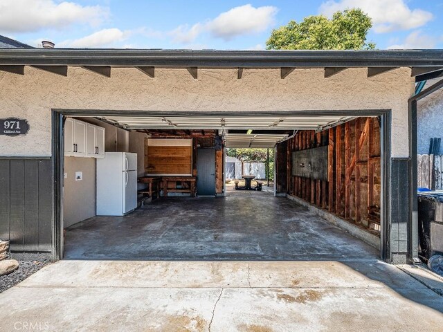 971 N Clifford Ave, Rialto, CA 92376 - garage with freestanding refrigerator and concrete driveway