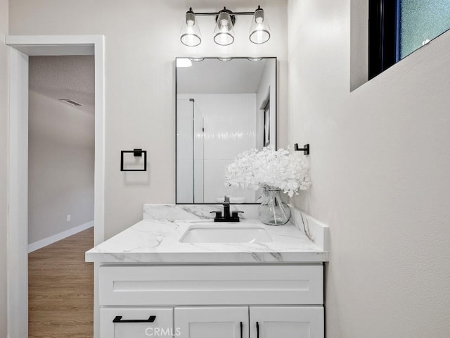 971 N Clifford Ave, Rialto, CA 92376 - bathroom featuring vanity, wood finished floors, and a shower