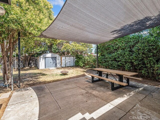 971 N Clifford Ave, Rialto, CA 92376 - fenced backyard with a shed, a patio area, and outdoor dining area