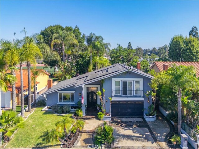 26301 Montarez Cir, Mission Viejo, CA 92691 - view of front of home featuring stucco siding, driveway, an attached garage, solar panels, and a front lawn