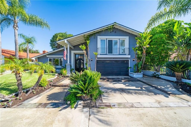 26301 Montarez Cir, Mission Viejo, CA 92691 - view of front of house featuring stucco siding, concrete driveway, a garage, and a balcony