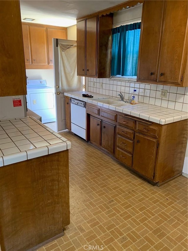 11818 Graystone, Norwalk, CA 90650 - kitchen with washer / dryer, white dishwasher, brick patterned flooring, and tile counters