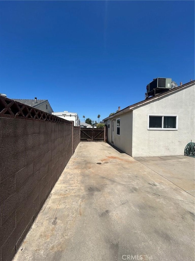 11818 Graystone, Norwalk, CA 90650 - view of side of home featuring a patio and stucco siding