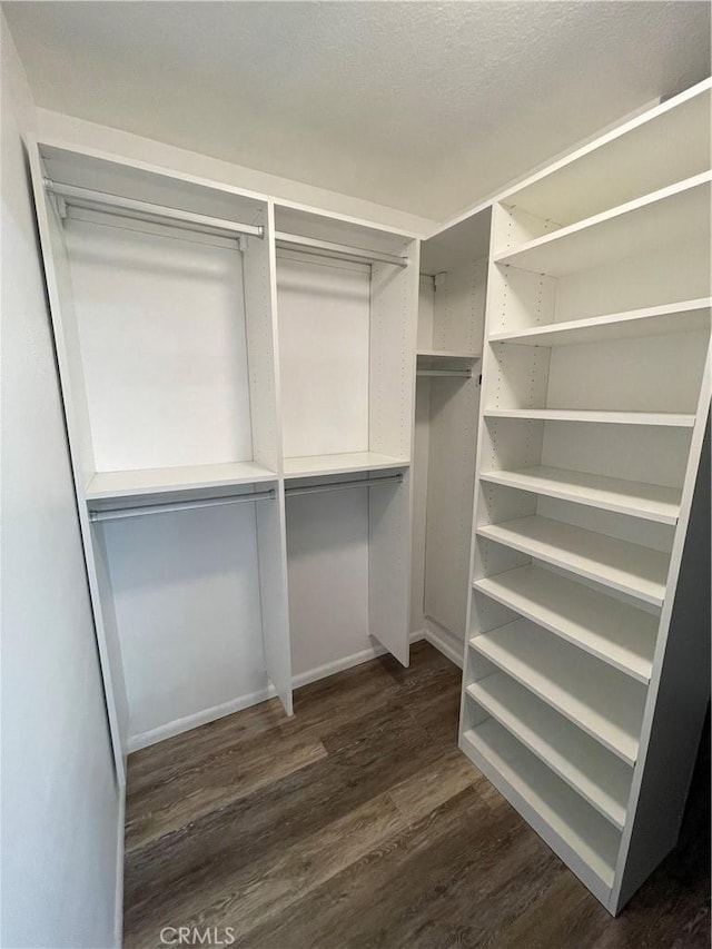 20331 Bluffside Cir Unit A320, Huntington Beach, CA 92646 - spacious closet featuring dark wood-type flooring