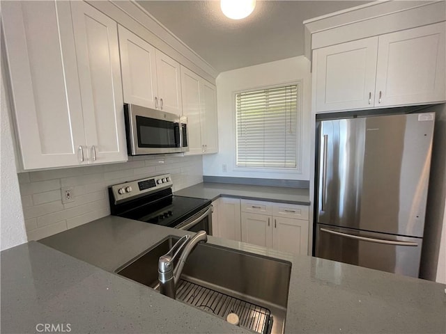20331 Bluffside Cir Unit A320, Huntington Beach, CA 92646 - kitchen featuring appliances with stainless steel finishes, backsplash, white cabinets, and dark stone counters