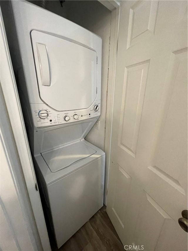 20331 Bluffside Cir Unit A320, Huntington Beach, CA 92646 - laundry room with stacked washer / dryer and dark wood-style floors
