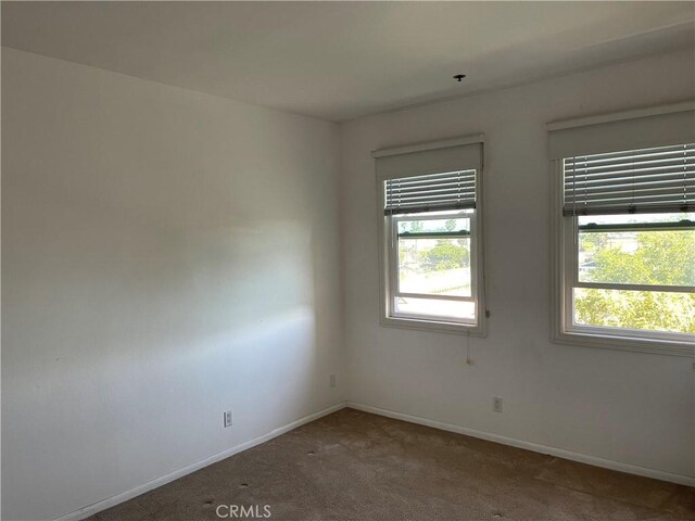 20331 Bluffside Cir Unit A320, Huntington Beach, CA 92646 - carpeted empty room featuring baseboards