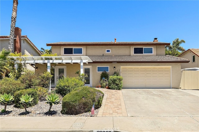 33262 Paseo Molinos, San Juan Capistrano, CA 92675 - view of front of home featuring stucco siding, a chimney, driveway, and a garage