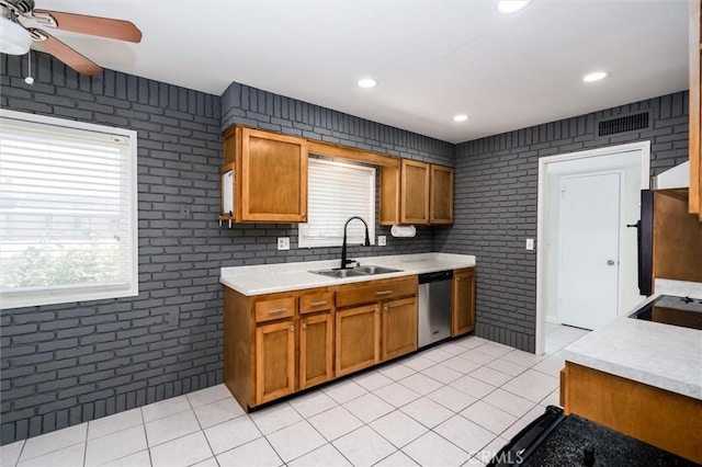 26409 Brandywine Ct, Menifee, CA 92586 - kitchen featuring dishwasher, brick wall, light tile patterned floors, light countertops, and brown cabinetry