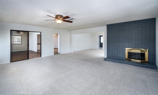 26409 Brandywine Ct, Menifee, CA 92586 - unfurnished living room featuring a ceiling fan, carpet floors, a fireplace, and a textured ceiling