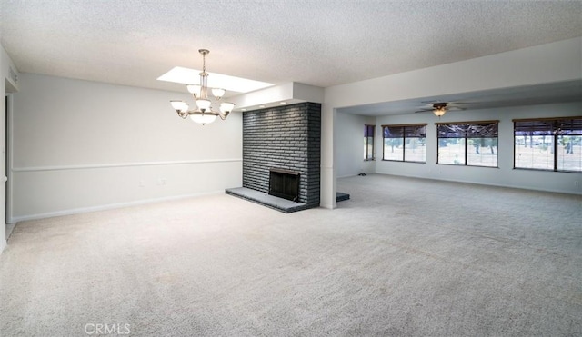 26409 Brandywine Ct, Menifee, CA 92586 - unfurnished living room featuring a textured ceiling, a chandelier, healthy amount of natural light, carpet floors, and a fireplace