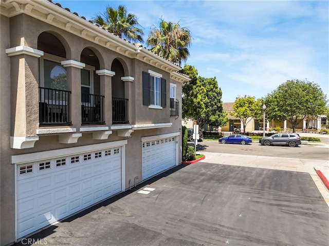 3393 Shadetree Way, Camarillo, CA 93012 - view of front of home with stucco siding, an attached garage, and a balcony