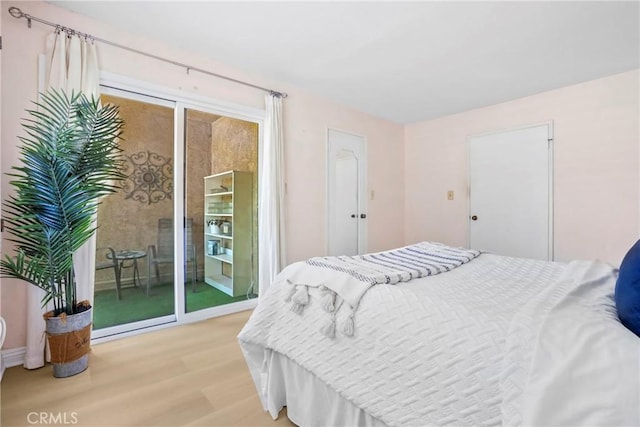 3511 Elm Ave Unit 212, Long Beach, CA 90807 - bedroom featuring access to exterior and light wood finished floors
