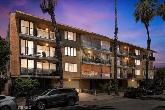 3511 Elm Ave Unit 212, Long Beach, CA 90807 - property at dusk featuring an attached garage