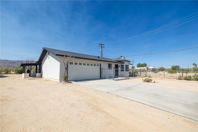 72011 Two Mile Rd Unit 29, Palms, CA 92277 - ranch-style home featuring an attached garage, driveway, and stucco siding
