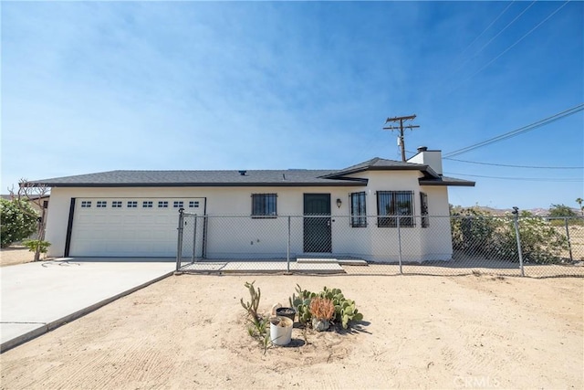 72011 Two Mile Rd Unit 29, Palms, CA 92277 - ranch-style house featuring an attached garage, driveway, stucco siding, and a chimney