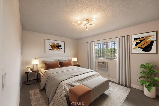 72011 Two Mile Rd Unit 29, Palms, CA 92277 - bedroom featuring a textured ceiling, a chandelier, and a wall mounted air conditioner