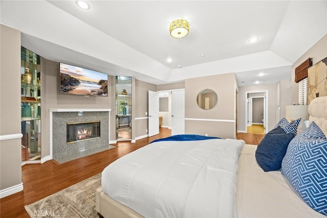826 Country Oaks Ln, Arcadia, CA 91006 - bedroom with wood finished floors, a fireplace, a tray ceiling, and recessed lighting