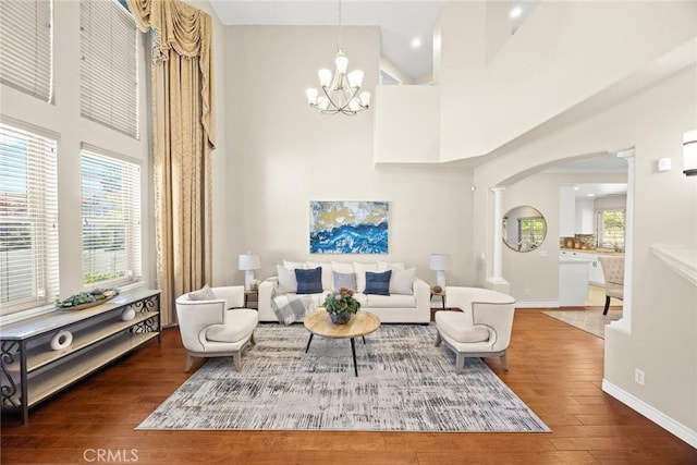826 Country Oaks Ln, Arcadia, CA 91006 - living area featuring ornate columns, wood-type flooring, arched walkways, a chandelier, and a high ceiling