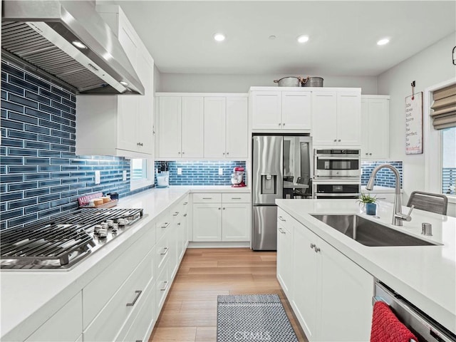 27717 Knoll View Pl, Valencia, CA 91381 - kitchen featuring wall chimney exhaust hood, stainless steel appliances, recessed lighting, light countertops, and tasteful backsplash