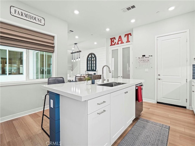 27717 Knoll View Pl, Valencia, CA 91381 - kitchen featuring light wood finished floors, white cabinetry, an island with sink, light countertops, and recessed lighting