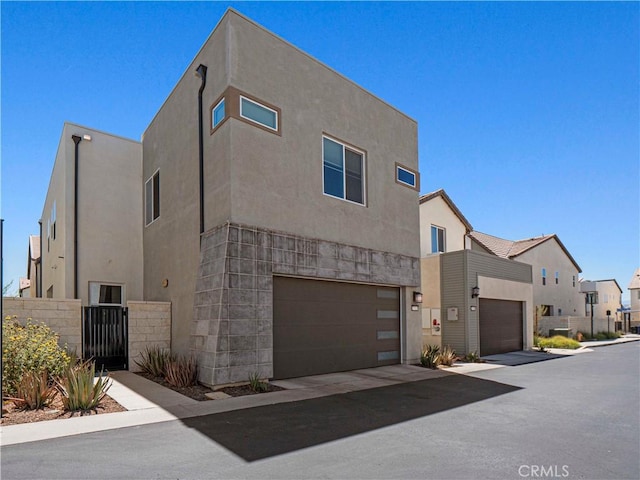 27717 Knoll View Pl, Valencia, CA 91381 - view of front facade featuring stucco siding, a garage, and a residential view