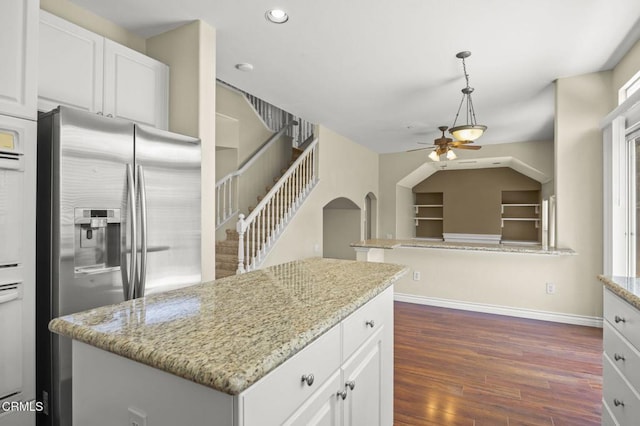 724 Parrish St, Ventura, CA 93003 - kitchen with stainless steel fridge, ceiling fan, dark wood-style floors, a center island, and light stone countertops