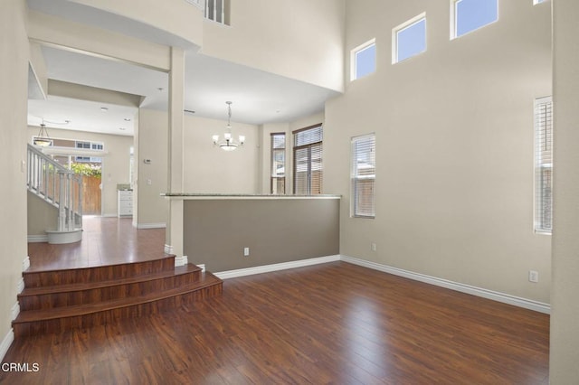 724 Parrish St, Ventura, CA 93003 - unfurnished room featuring wood finished floors, stairs, a chandelier, and a high ceiling