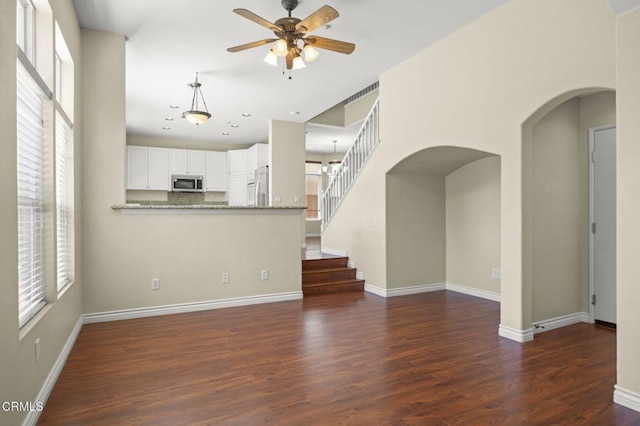 724 Parrish St, Ventura, CA 93003 - unfurnished living room with ceiling fan, arched walkways, dark wood-style flooring, stairway, and recessed lighting