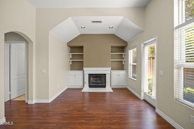 724 Parrish St, Ventura, CA 93003 - unfurnished living room with built in features, healthy amount of natural light, dark wood-style flooring, and vaulted ceiling