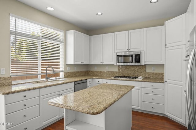 724 Parrish St, Ventura, CA 93003 - kitchen with appliances with stainless steel finishes, white cabinets, dark wood finished floors, a center island, and recessed lighting