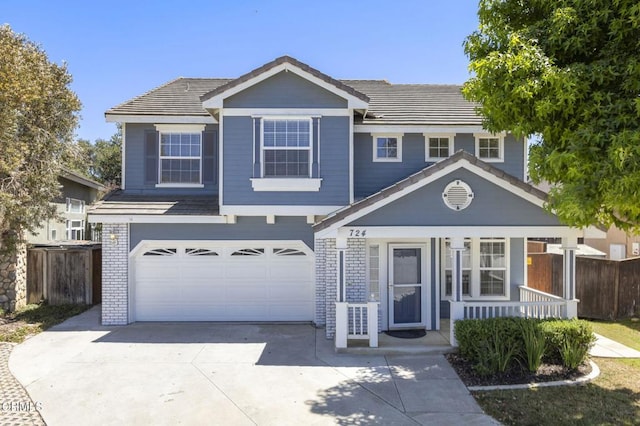 724 Parrish St, Ventura, CA 93003 - traditional-style house with covered porch, concrete driveway, an attached garage, brick siding, and a tile roof