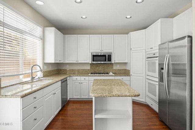 724 Parrish St, Ventura, CA 93003 - kitchen featuring appliances with stainless steel finishes, white cabinetry, light stone countertops, recessed lighting, and open shelves