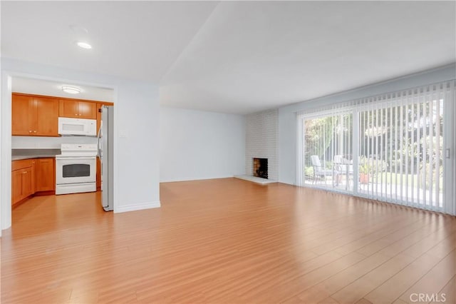 22913 Nadine Cir Unit A, Torrance, CA 90505 - unfurnished living room with light wood-style floors and a fireplace