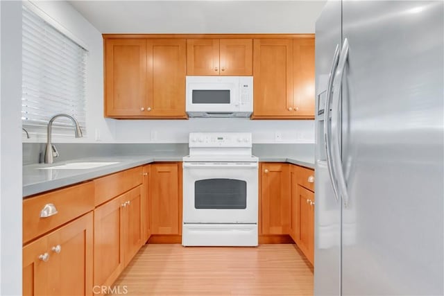 22913 Nadine Cir Unit A, Torrance, CA 90505 - kitchen featuring white appliances, light wood-style flooring, light countertops, and brown cabinets