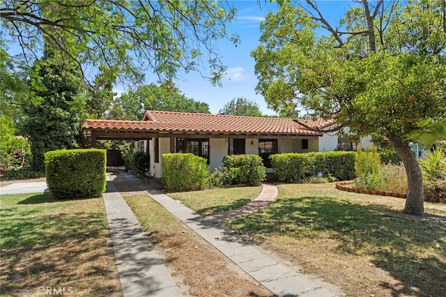 733 W 24th St, San Bernardino, CA 92405 - mediterranean / spanish-style home with a tile roof, stucco siding, a front yard, an attached carport, and driveway