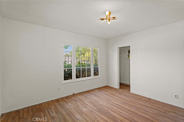 733 W 24th St, San Bernardino, CA 92405 - unfurnished bedroom featuring wood finished floors and a spacious closet