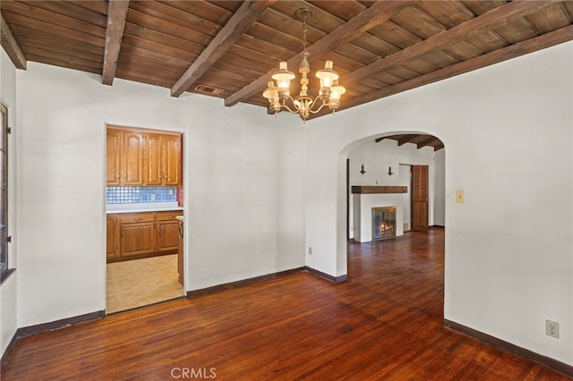 733 W 24th St, San Bernardino, CA 92405 - unfurnished dining area with a wooden ceiling with exposed beams, arched walkways, dark wood-type flooring, a chandelier, and a warm lit fireplace