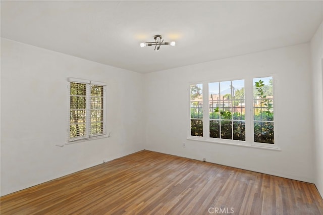 733 W 24th St, San Bernardino, CA 92405 - spare room featuring plenty of natural light, wood finished floors, and a chandelier