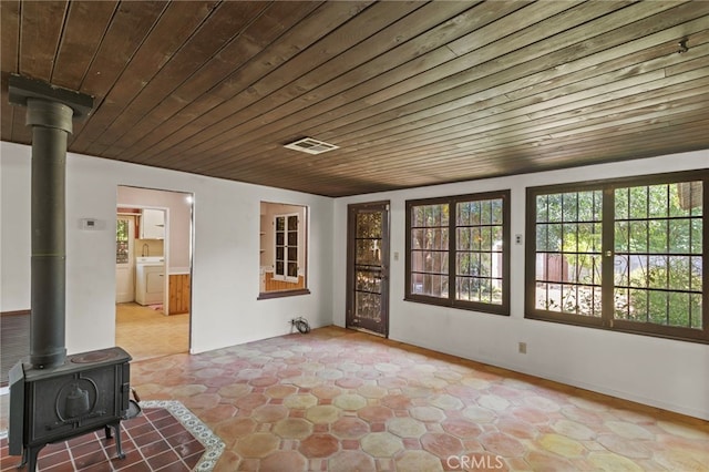 733 W 24th St, San Bernardino, CA 92405 - unfurnished sunroom with a wood stove and independent washer and dryer