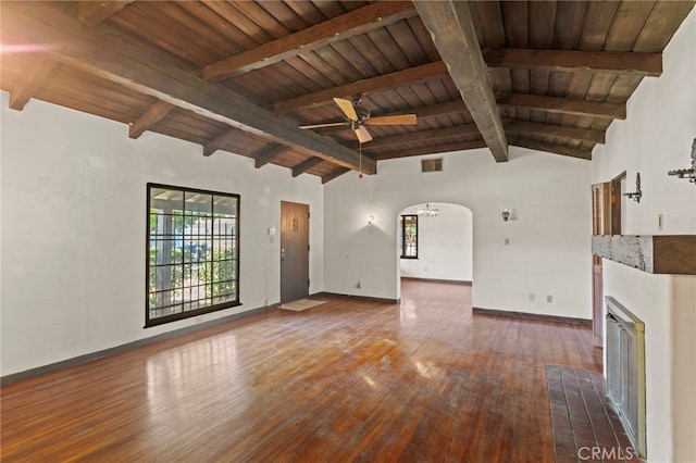 733 W 24th St, San Bernardino, CA 92405 - unfurnished living room featuring wood ceiling, healthy amount of natural light, dark wood-style floors, arched walkways, and ceiling fan