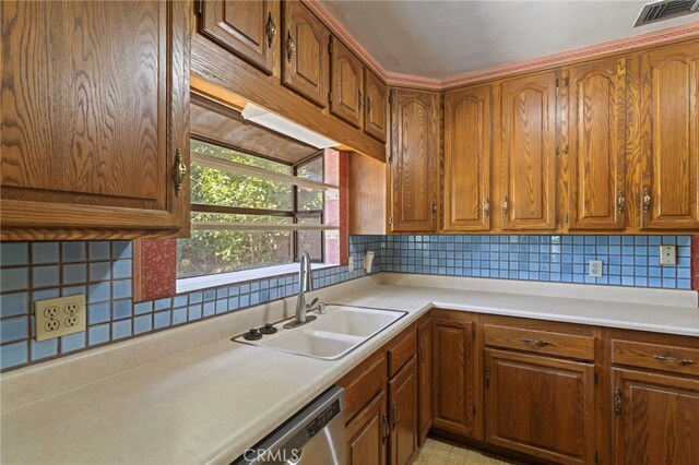733 W 24th St, San Bernardino, CA 92405 - kitchen featuring brown cabinets, light countertops, and backsplash