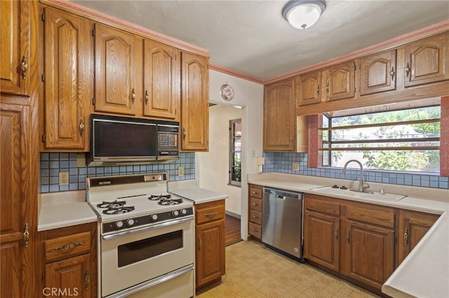 733 W 24th St, San Bernardino, CA 92405 - kitchen featuring black microwave, stainless steel dishwasher, white range with gas stovetop, light countertops, and ornamental molding