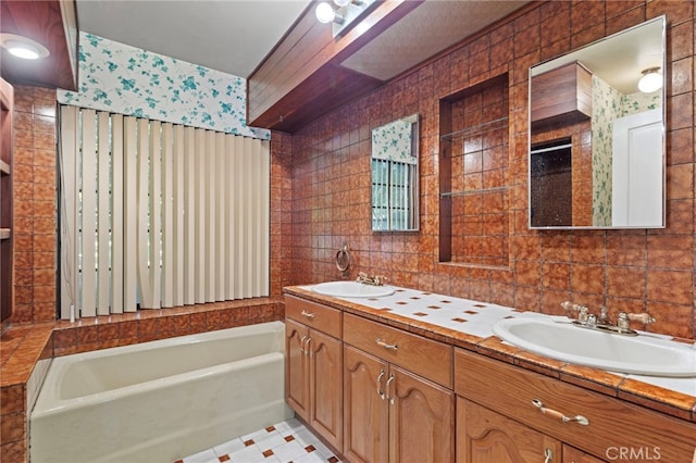 733 W 24th St, San Bernardino, CA 92405 - full bathroom featuring tile walls, a tub to relax in, and double vanity