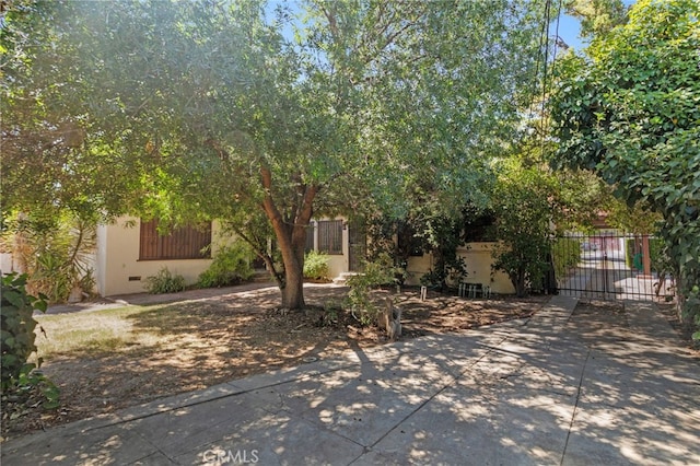 733 W 24th St, San Bernardino, CA 92405 - obstructed view of property featuring driveway, a gate, and stucco siding