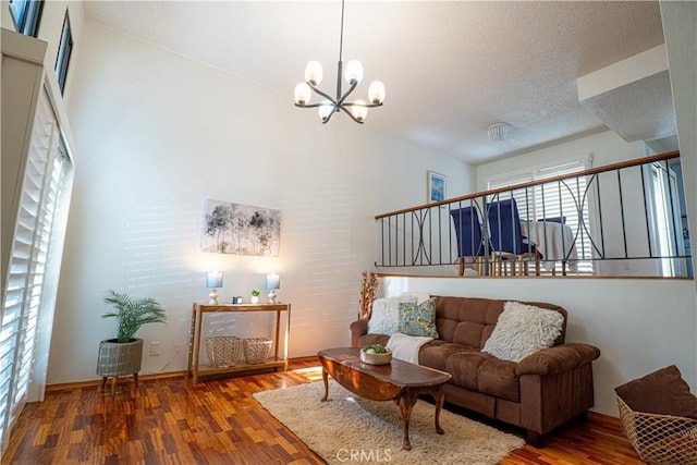9620 Sepulveda Blvd Unit 4, North Hills, CA 91343 - living room with healthy amount of natural light, wood finished floors, a chandelier, and a textured ceiling