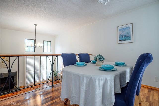 9620 Sepulveda Blvd Unit 4, North Hills, CA 91343 - dining area featuring a chandelier, a textured ceiling, and wood finished floors